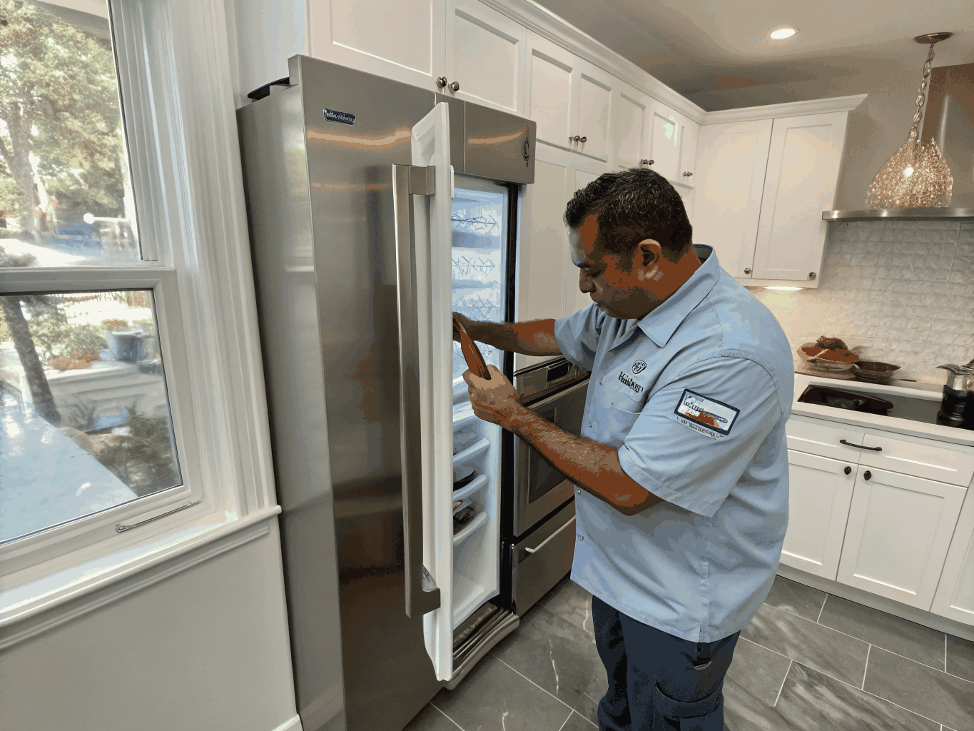 Technician inspecting a refrigerator freezer unit in Morrow Georgia